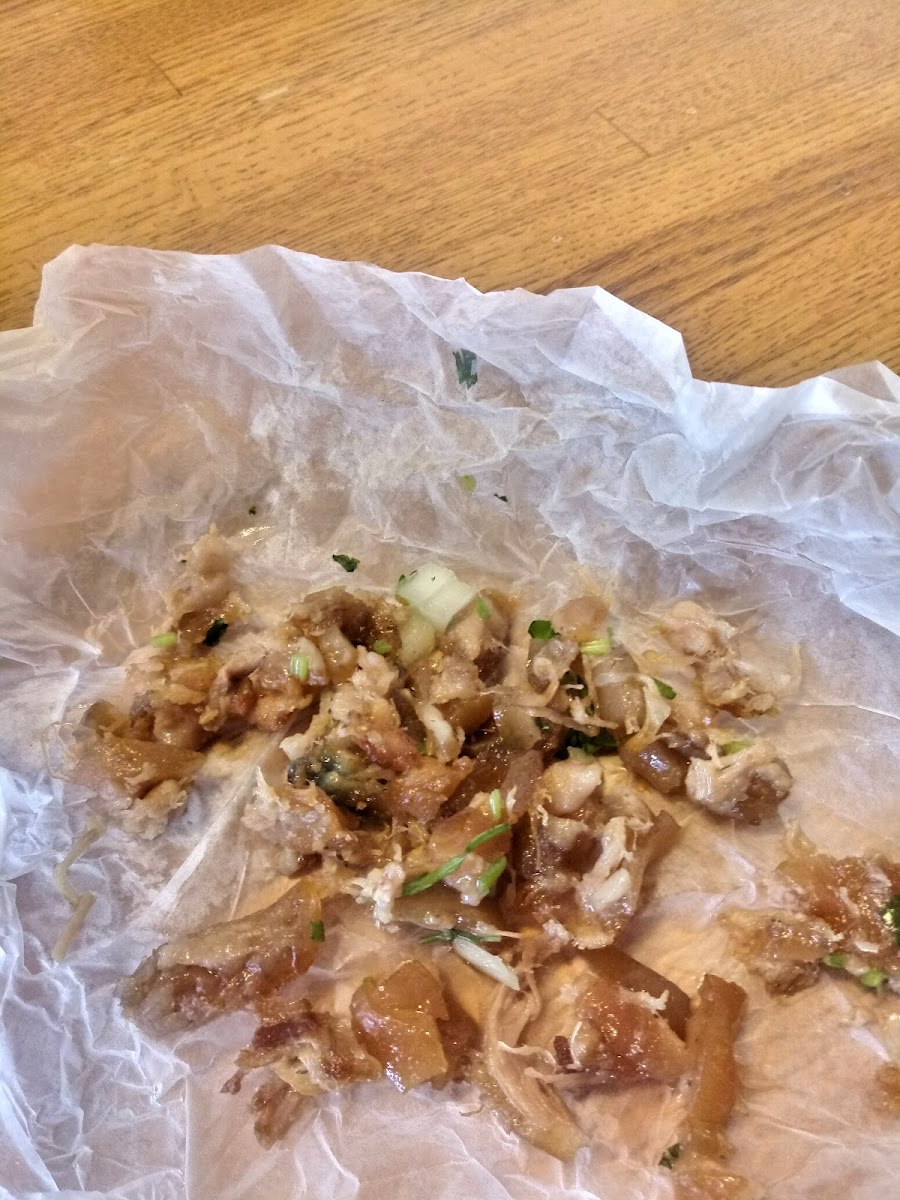 A platter of street tacos topped with cilantro and onion